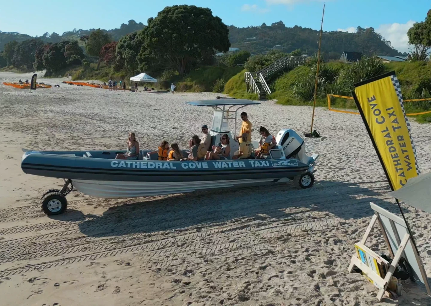 Our amphibious water taxi waiting on Hahei Beach beside the yellow flag