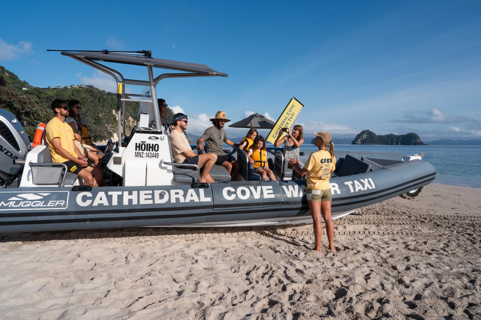 Passengers and crew aboard the water taxi on the beach