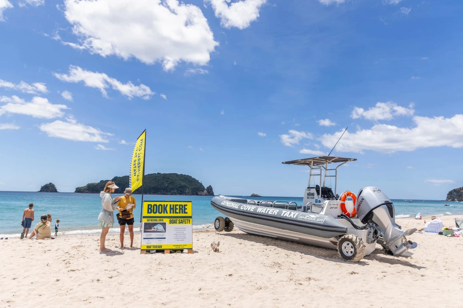 Meet the water taxi beside the yellow flags on Hahei Beach